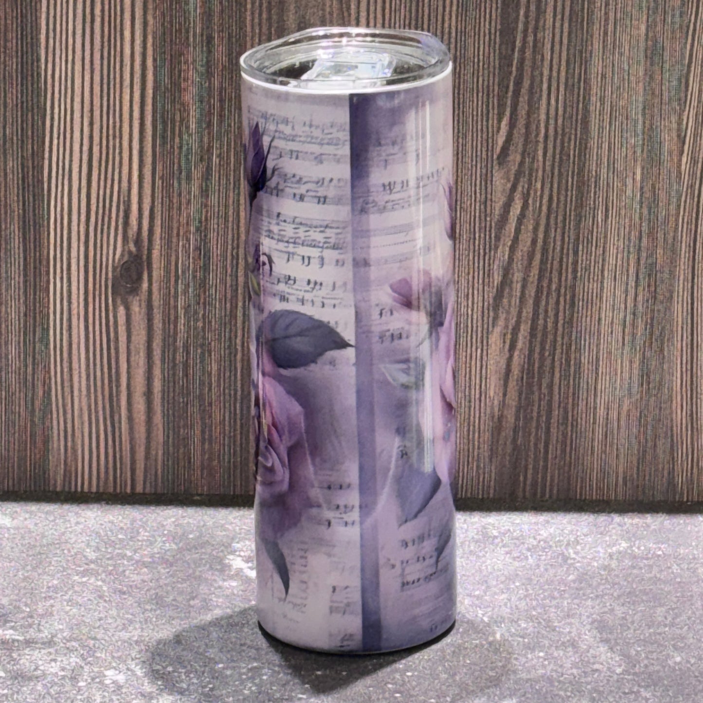 20 oz stainless steel skinny tumbler featuring a radiant Christian cross surrounded by sunflowers, butterflies, and sheet music artwork.