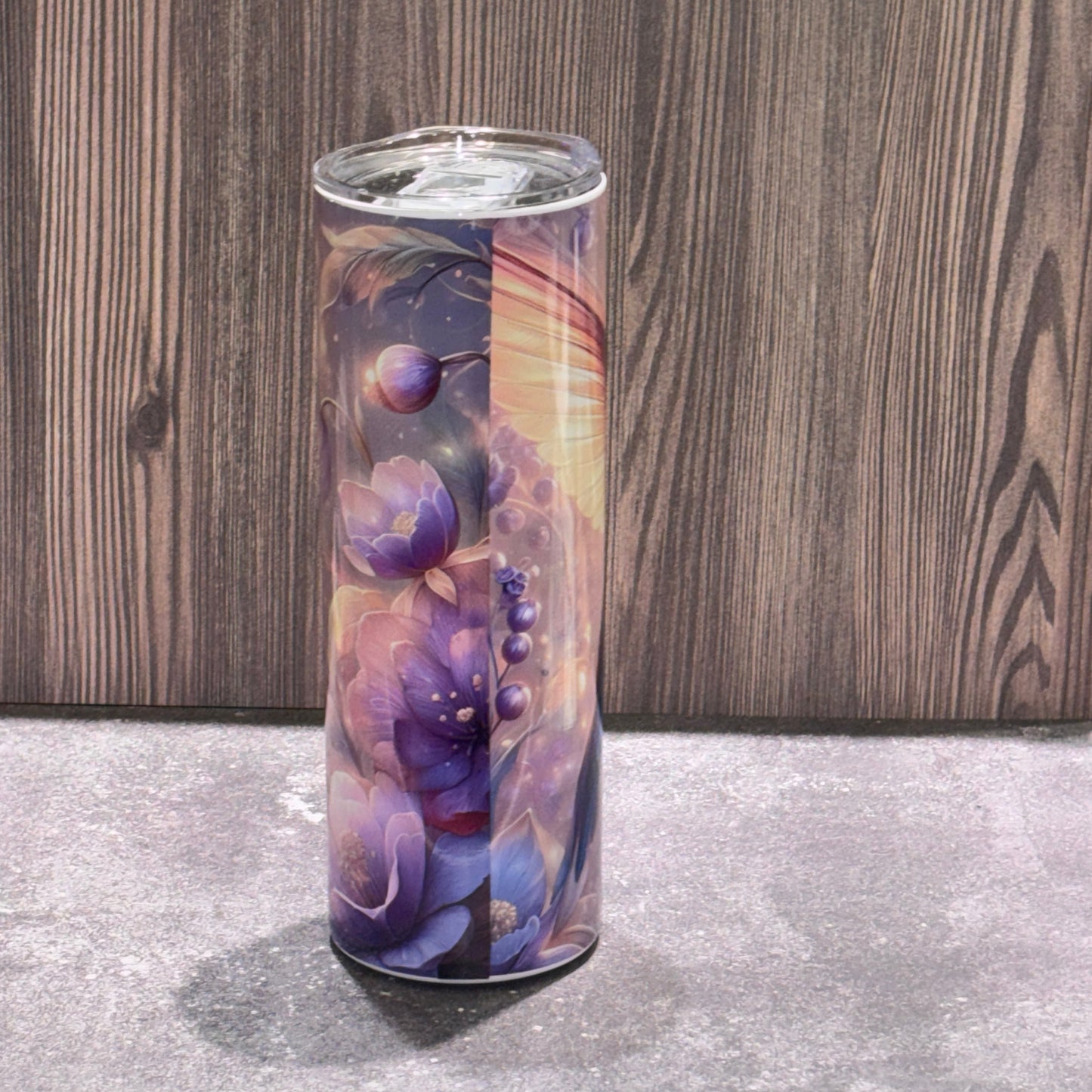 20 oz stainless steel skinny tumbler featuring a colorful hummingbird surrounded by soft floral and nature-inspired artwork.