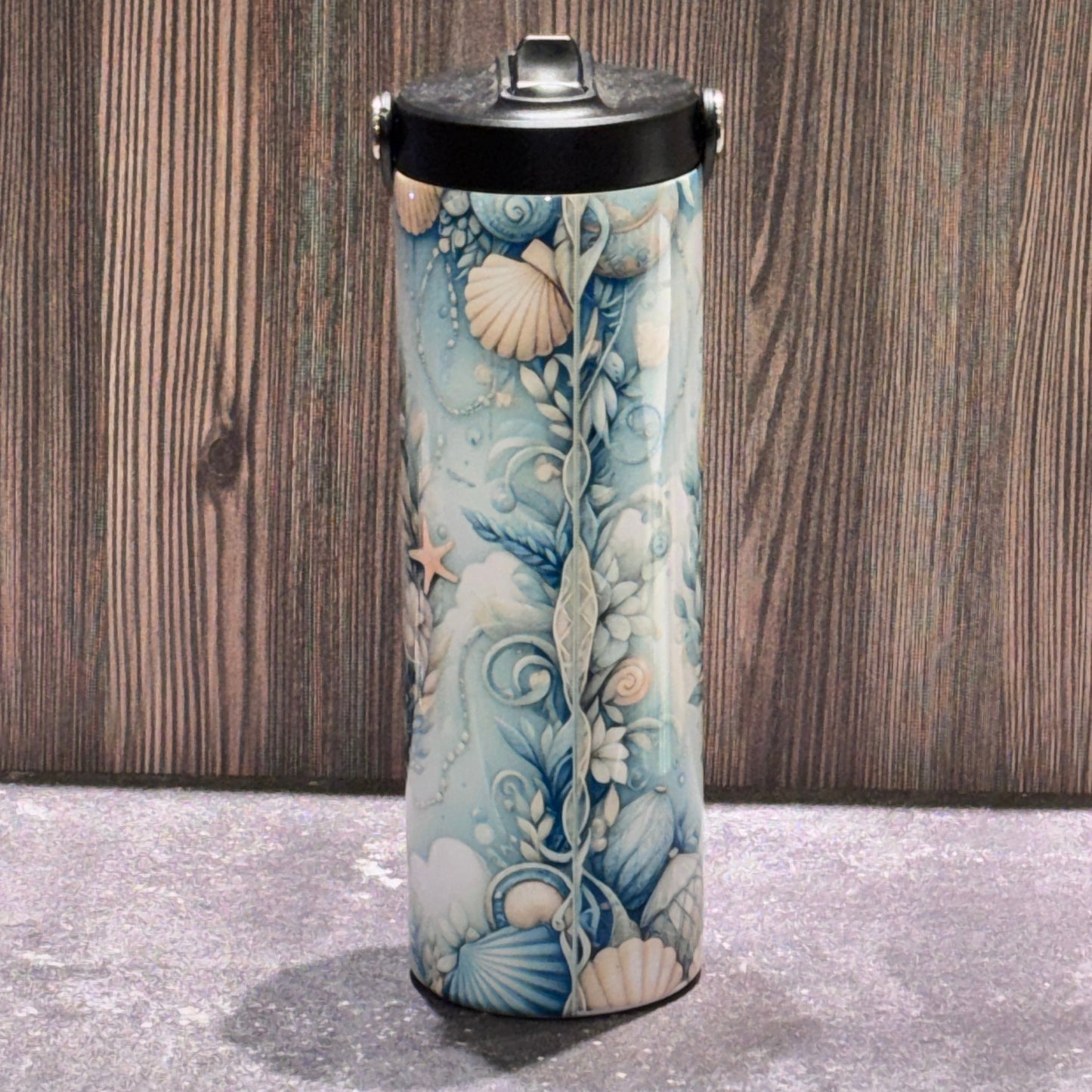 20 oz stainless steel leakproof water bottle featuring a coastal beach design with seashells, starfish, ocean artwork, and Life Is Better at the Beach text.
