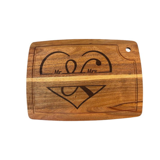 Wooden cutting board with 'Mr. Mrs.' engraving on a white background
