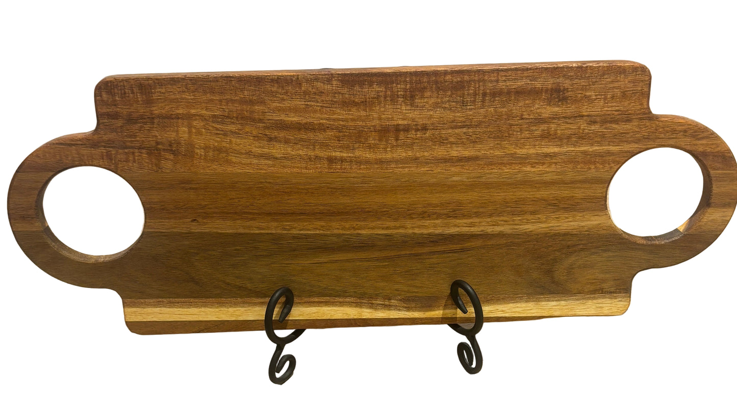 Wooden serving board with handles on a stand against a wooden background