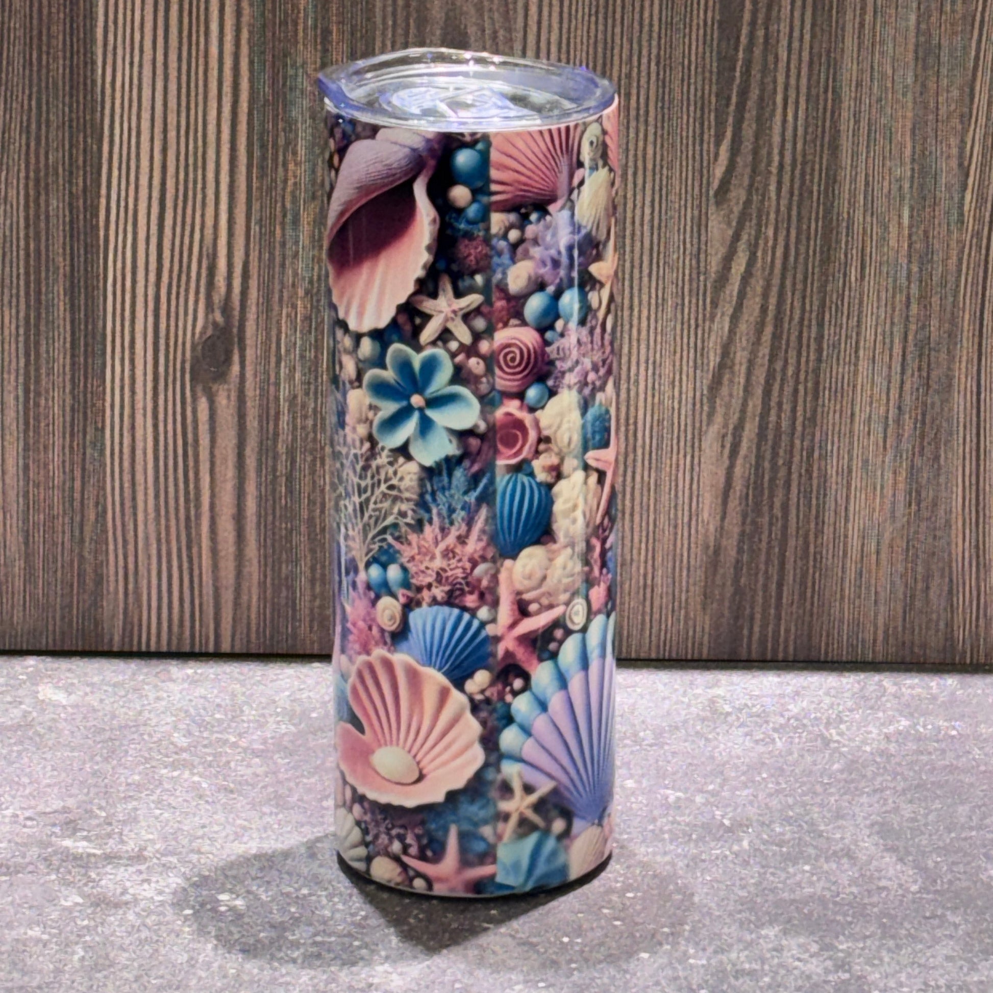 Colorful tumbler with sea-themed design on a wooden surface