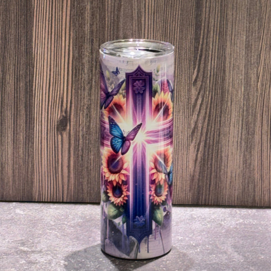 20 oz stainless steel skinny tumbler featuring a radiant Christian cross surrounded by sunflowers, butterflies, and sheet music artwork.