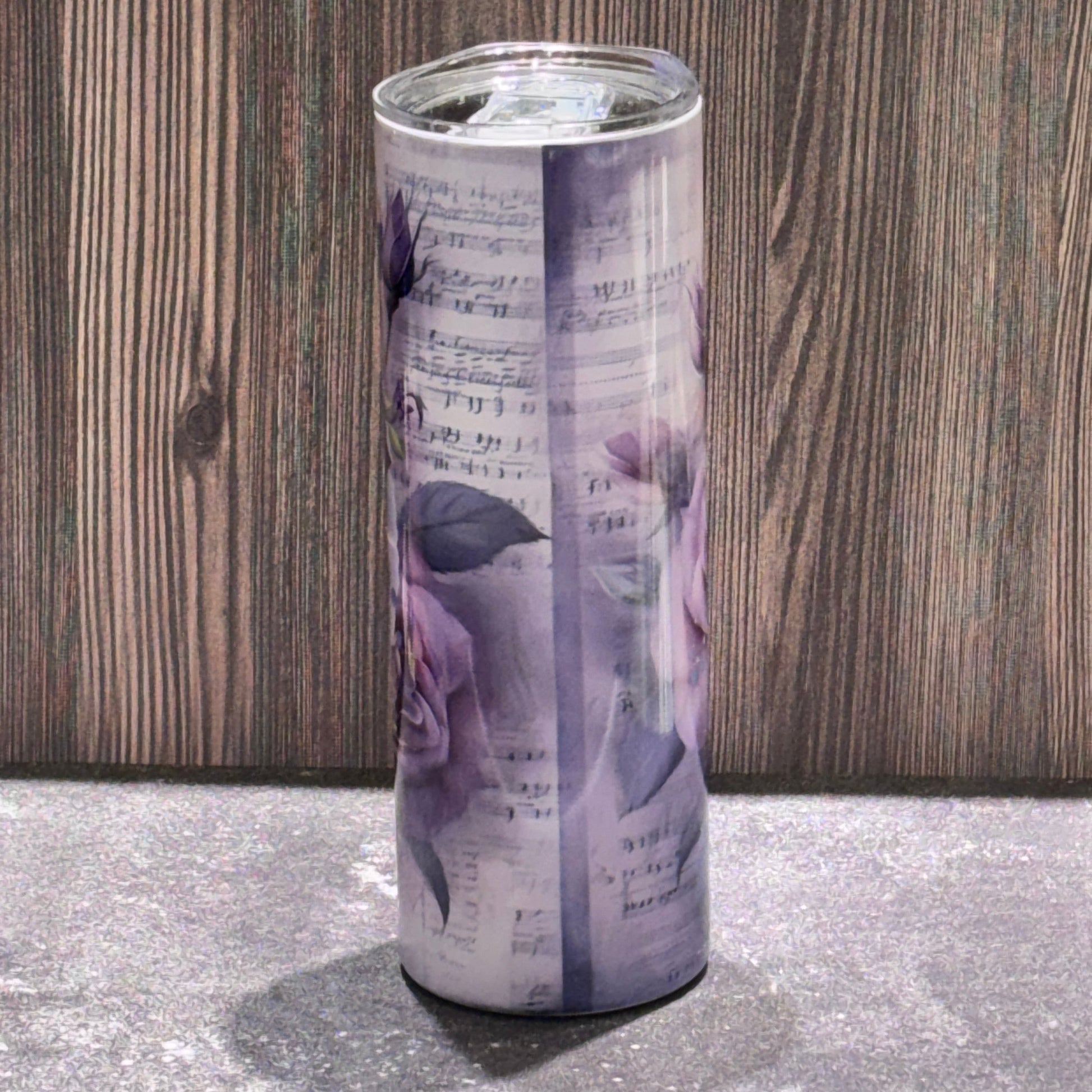 20 oz stainless steel skinny tumbler featuring a radiant Christian cross surrounded by sunflowers, butterflies, and sheet music artwork.