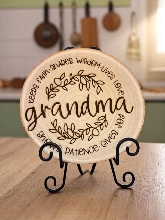 Natural 8 to 9 inch wood slice engraved with the word “grandma” surrounded by leaves and heartfelt phrases. Stand not included.