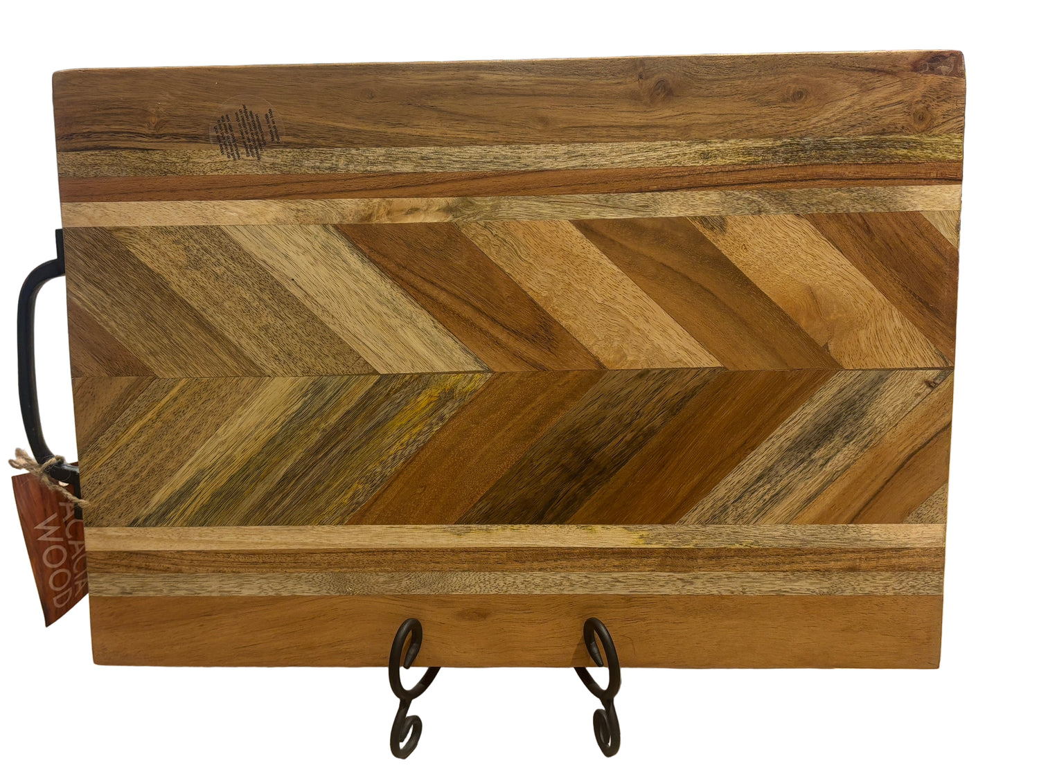 Herringbone pattern acacia wood charcuterie board with rich tonal contrast on tabletop display stand