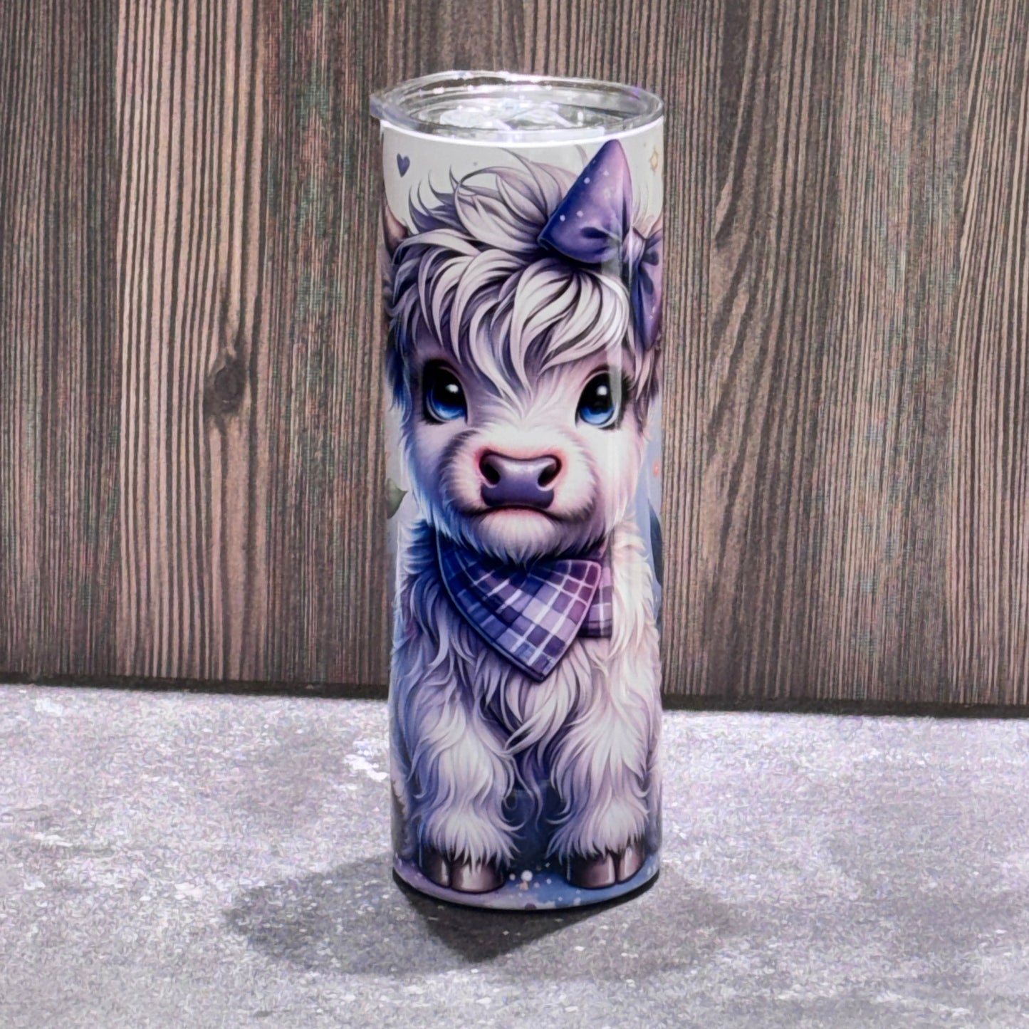 20 oz stainless steel skinny tumbler featuring a cute Highland cow illustration with sunflower artwork on the reverse side.