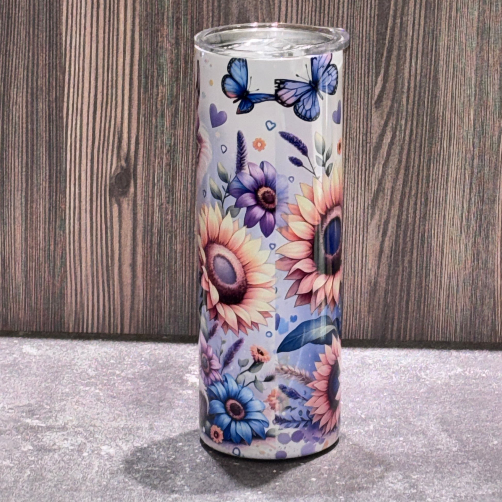 20 oz stainless steel skinny tumbler featuring a cute Highland cow illustration with sunflower artwork on the reverse side.