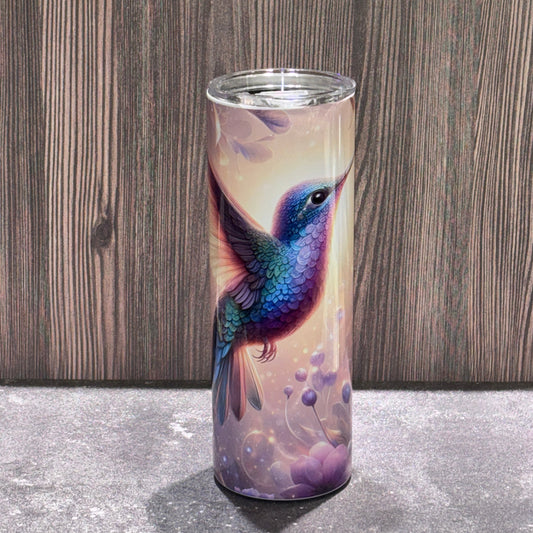 20 oz stainless steel skinny tumbler featuring a colorful hummingbird surrounded by soft floral and nature-inspired artwork.