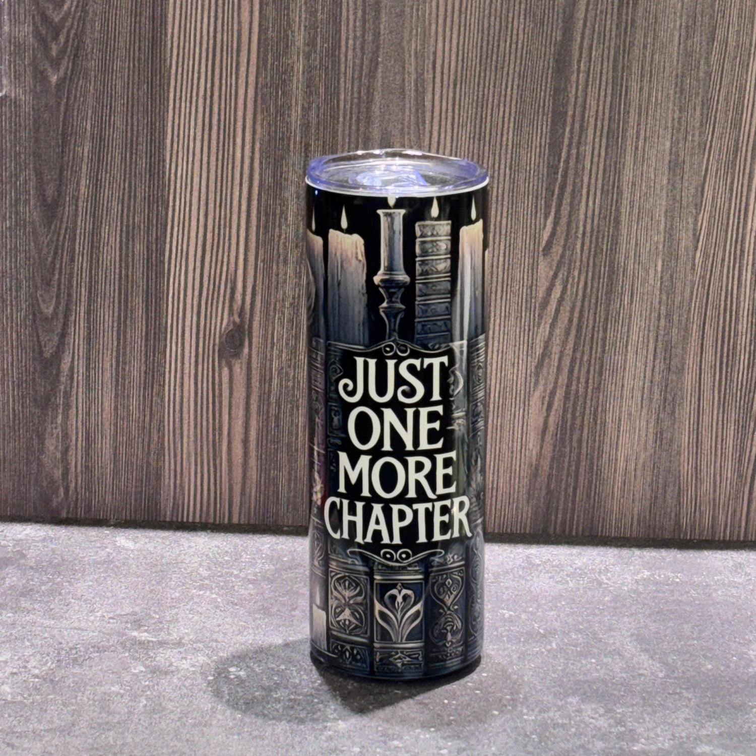 20 oz stainless steel skinny tumbler featuring a vintage library design with books, candles, and the phrase Just One More Chapter.