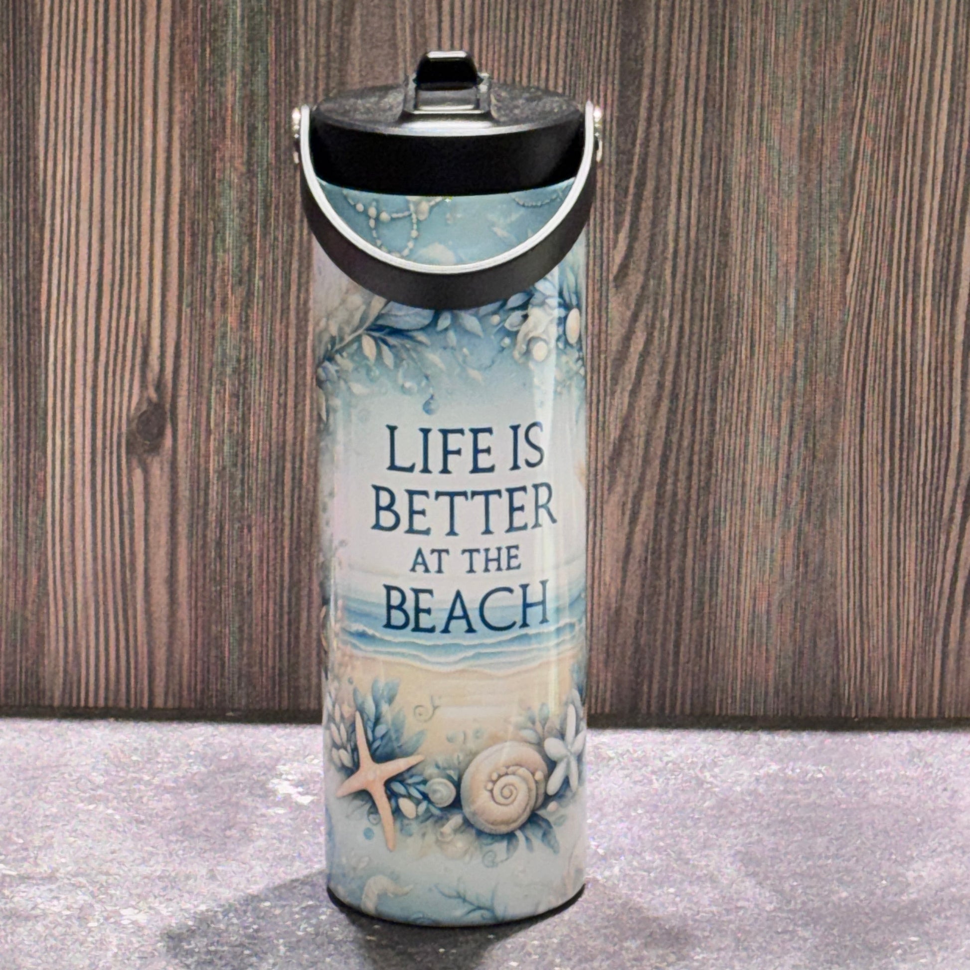 20 oz stainless steel leakproof water bottle featuring a coastal beach design with seashells, starfish, ocean artwork, and Life Is Better at the Beach text.