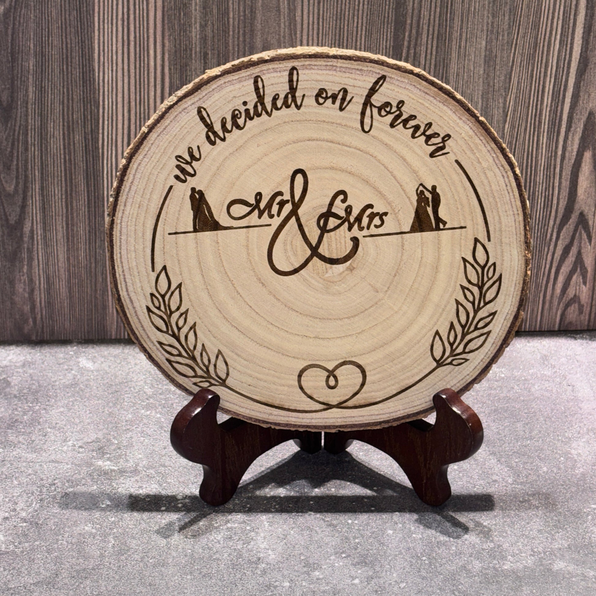 Natural 8 to 9 inch wood slice engraved with the phrase "We Decided on Forever" and Mr. & Mrs. lettering. Stand not included.