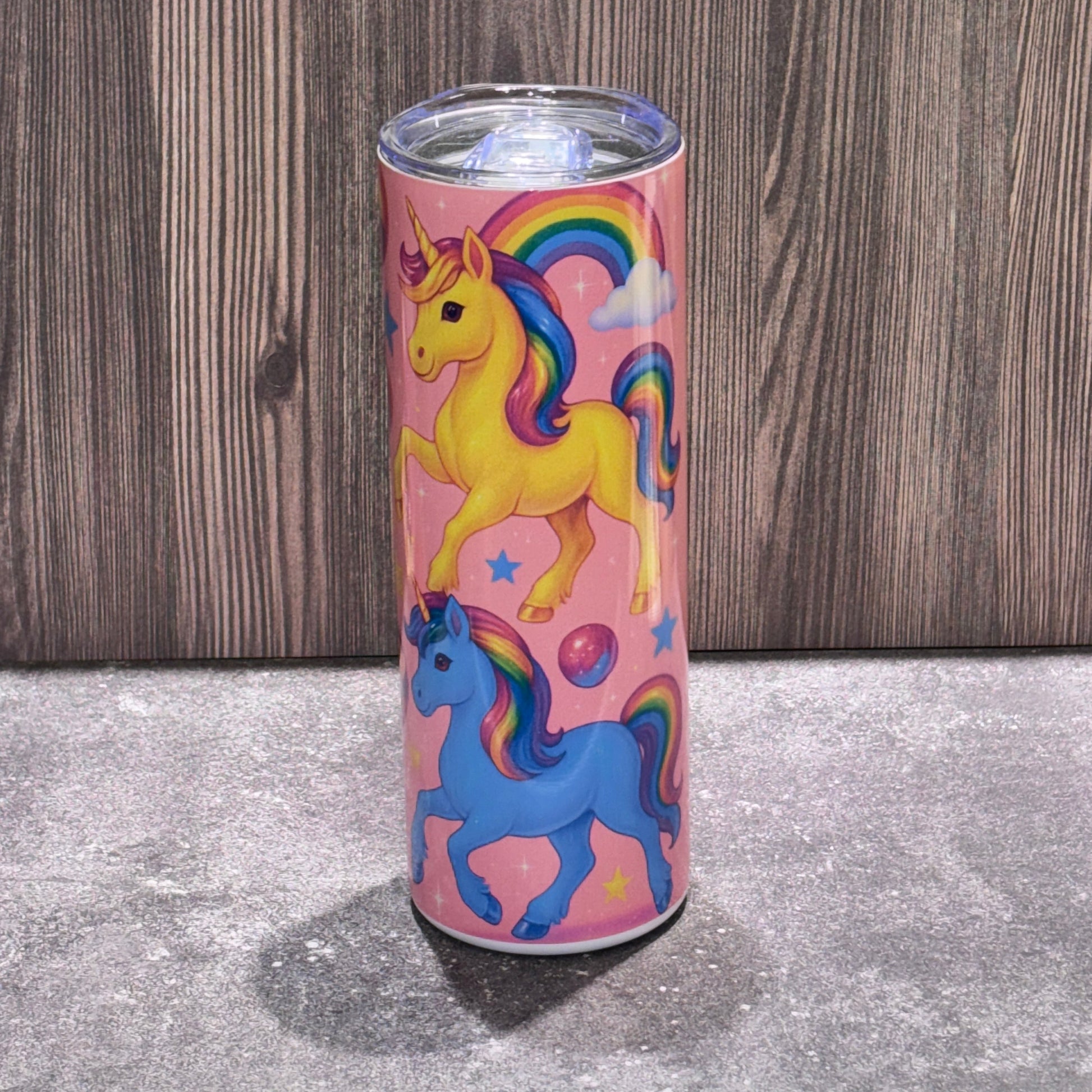 Colorful tumbler with cartoon characters on a wooden surface