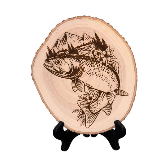 Wooden plaque with engraved fish and mountain design on a white background
